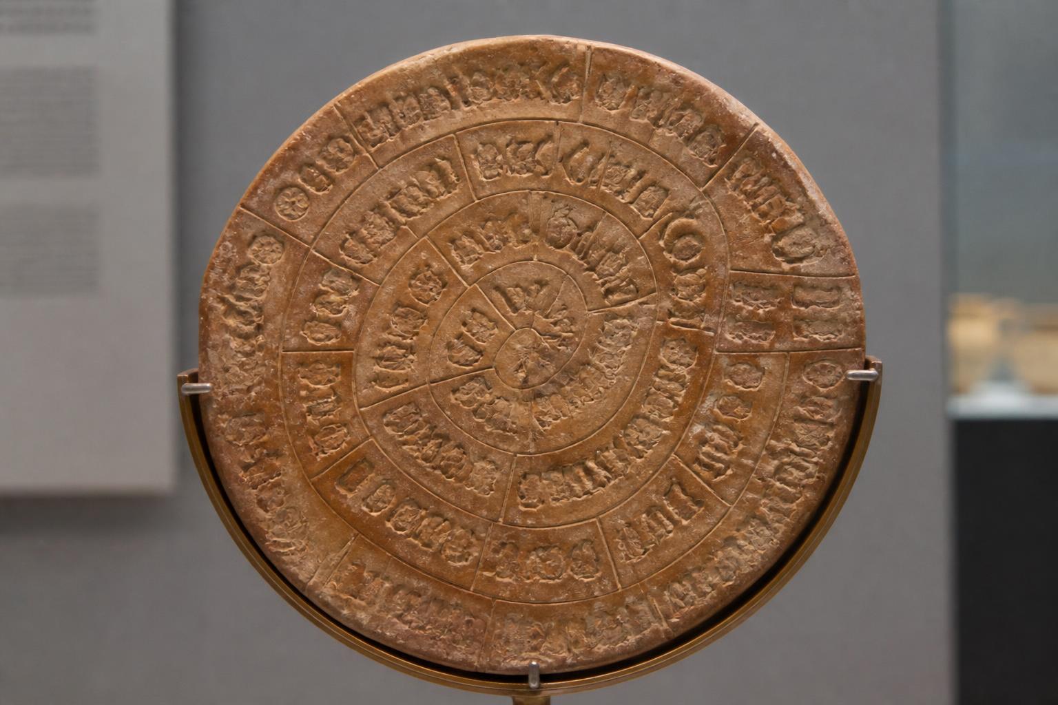 The Phaistos Disc showing spiral rows of stamped Bronze Age symbols on fired clay.